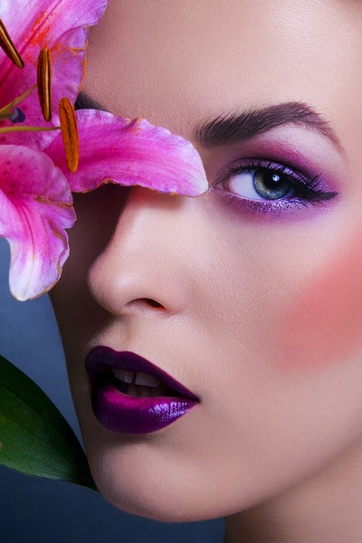 Close beauty shot of model with wild lily flower